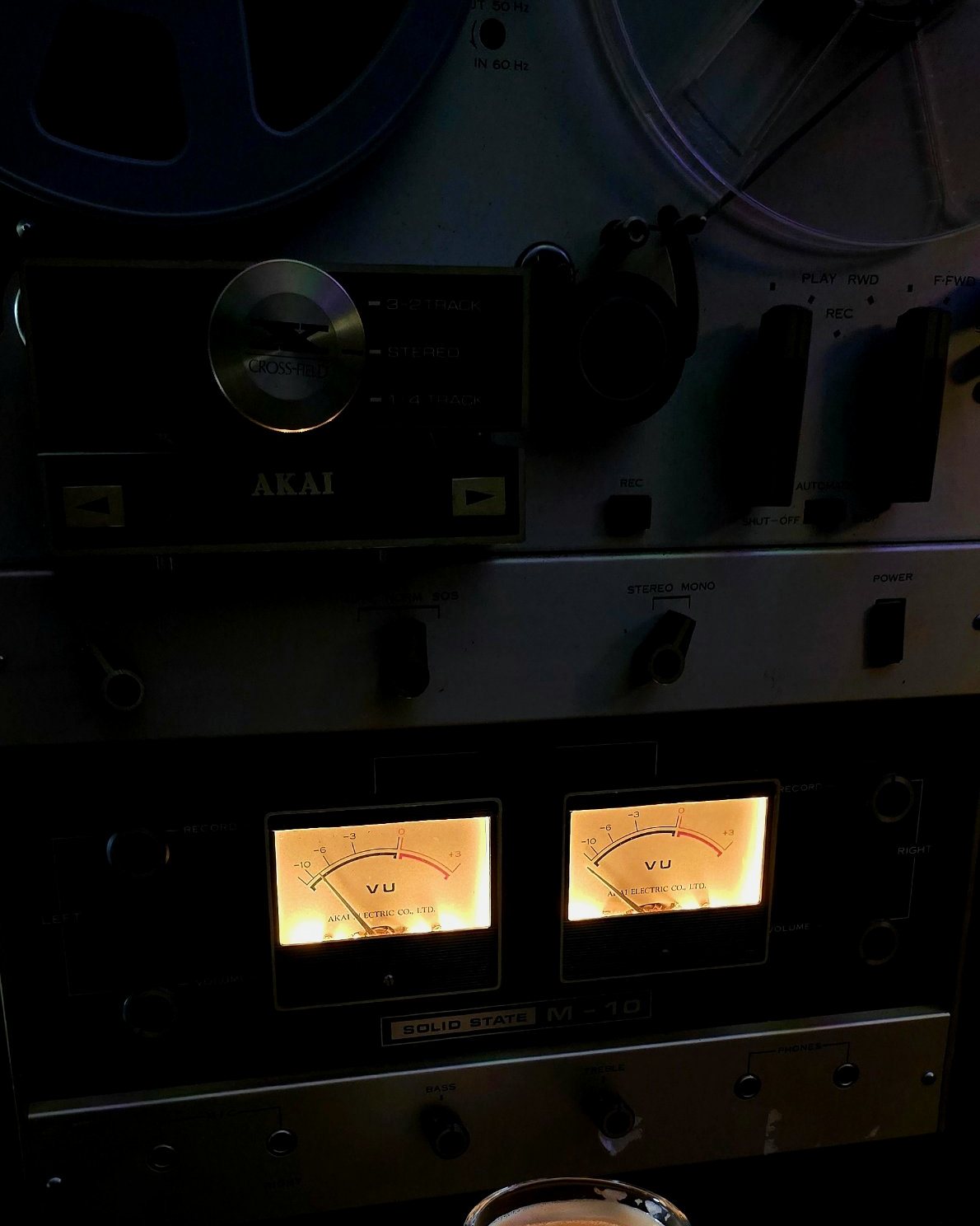 The Akai reel-to-reel deck with both VU meters lit