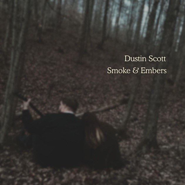 Smoke & Embers single cover: two people seated among bare trees in winter woods
